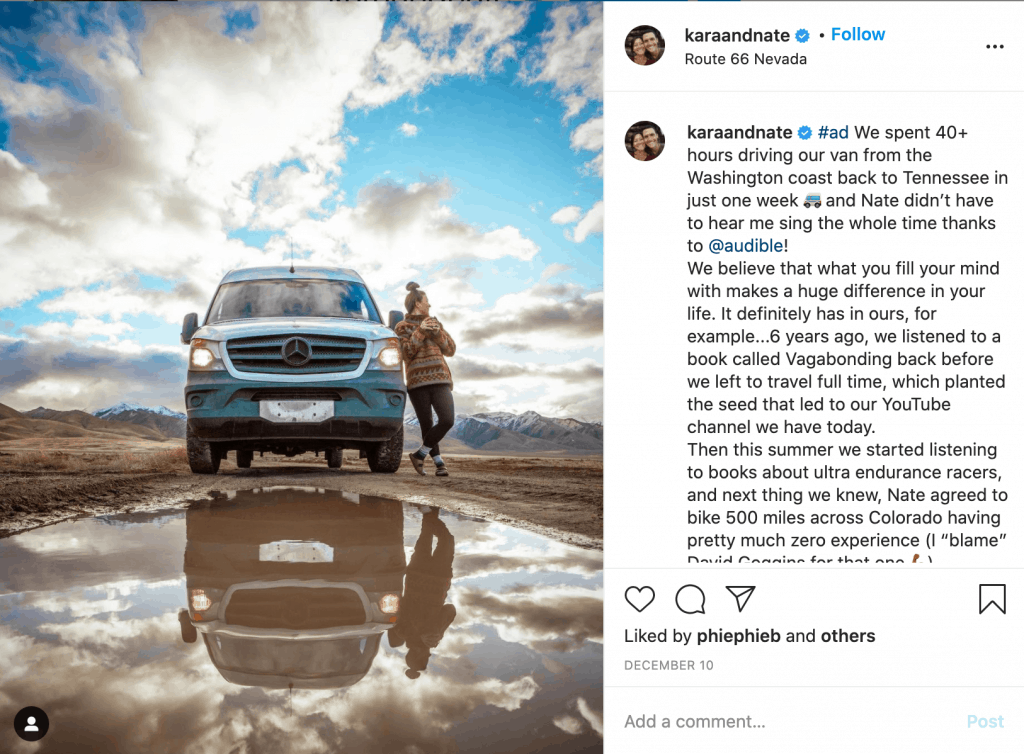 Travel influencers Kara and Nate with a photo of their van.
